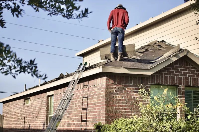 Professional roofer working on a residential roof in Kasota